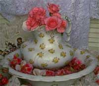 Rose arrangement in antique pitcher